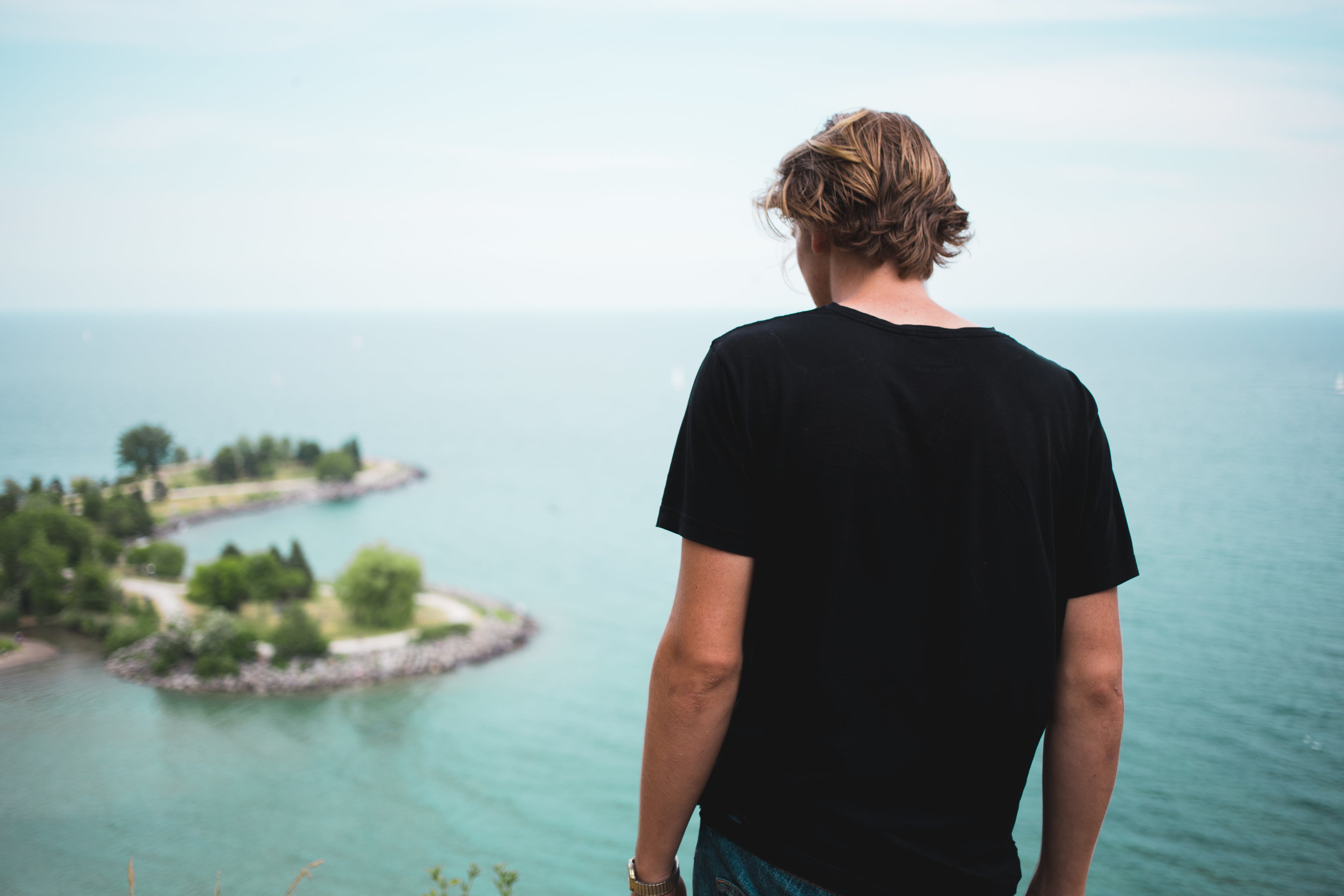 man views water wearing black nei-ldn t-shirt